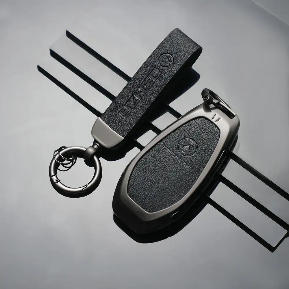 DENZA branded car key fob with leather keychain, sleek metal design for luxury EVs