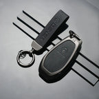 DENZA branded car key fob with leather keychain, sleek metal design for luxury EVs