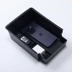 Black car console organizer tray holding iPhone, car key, and charger, ideal for EV accessories storage.