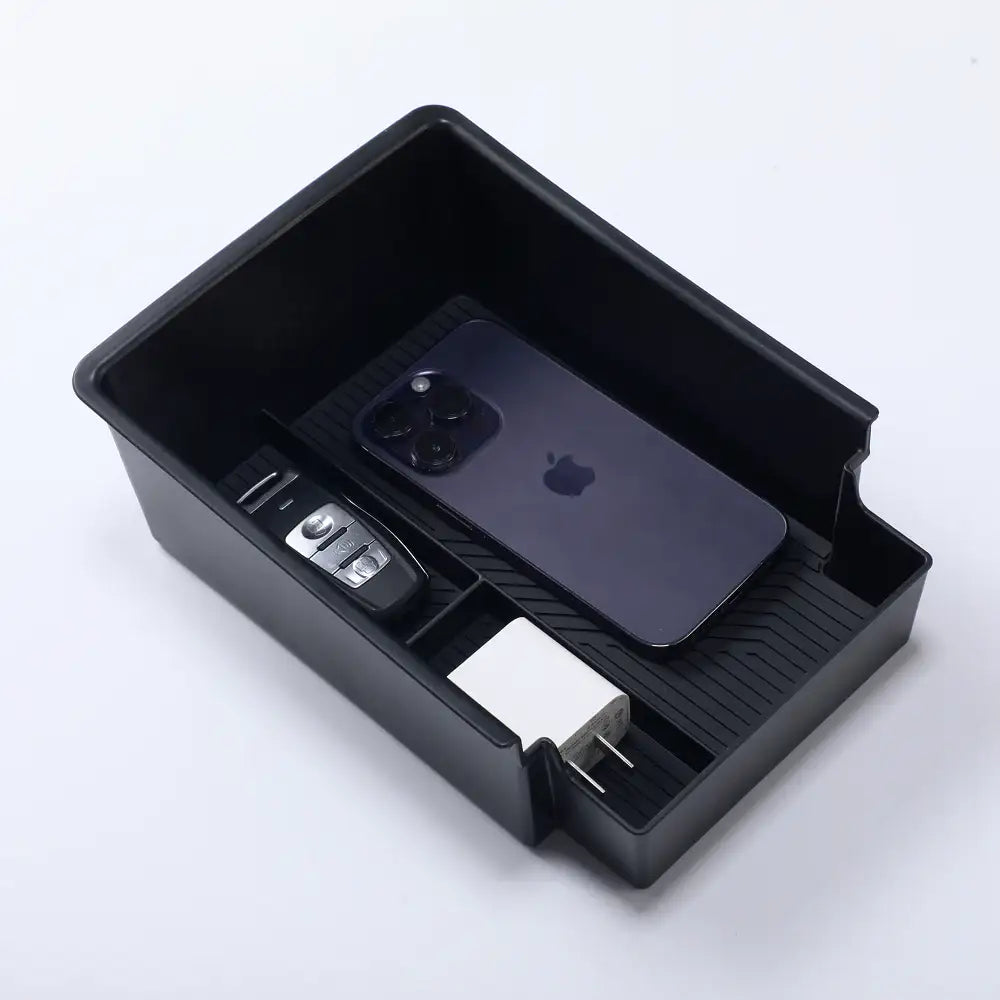 Black car console organizer tray holding iPhone, car key, and charger, ideal for EV accessories storage.