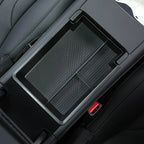 Black textured car center console organizer with red accents for EV interiors