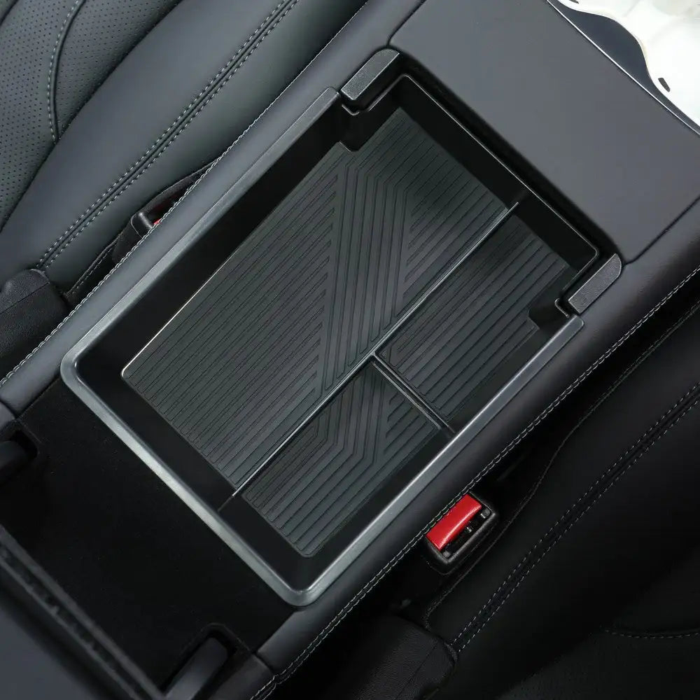Black textured car center console organizer with red accents for EV interiors